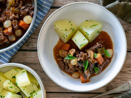 Braised beef bourguignon with mushroom, bacon, onions and parsley potatoes