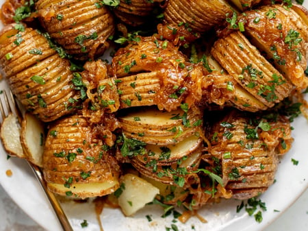 Hasselback potatoes with rosemary salt and caramelised onions