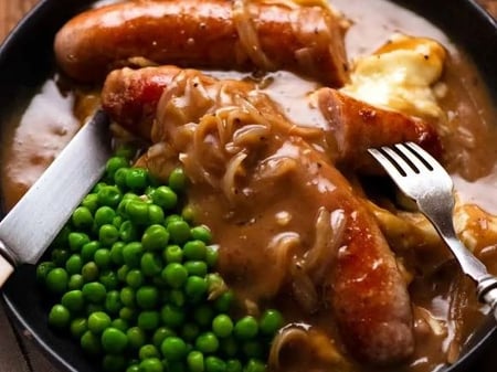 Bangas & Mash with Baby Peas & Onion Gravy