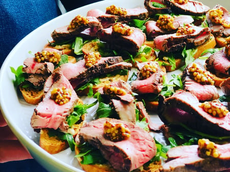 rare roast beef horseradish roquette on crostini