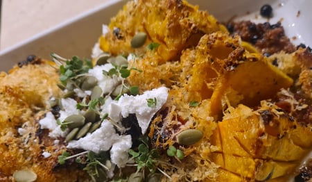 Pumpkin Hasselback with couscous and parmesan crust