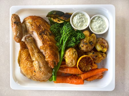 Greek chicken roast with lemon & thyme, garlic potatoes, vegetables & tzatziki