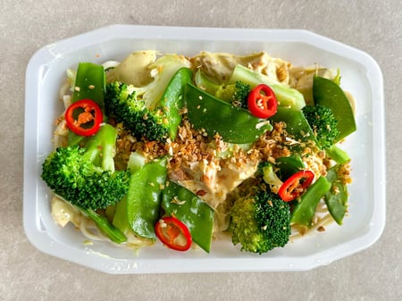 Satay chicken with Udon noodles, broccoli, snow peas and crispy garlic