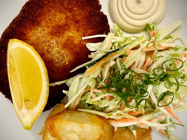 Beef Schnitzel w/ Potato Wedges, Coleslaw & Lemon