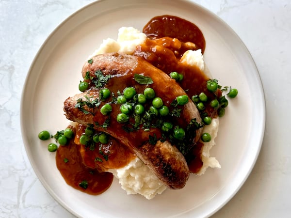 Pork & Fennel Sausages, mashed potato, garden peas and onion gravy