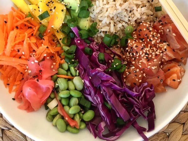 Teriyaki Salmon poke bowl, brown rice, edamame beans, miso ginger dressing.