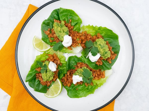 Walnut 'meat' lettuce tacos with sour cream and guacamole