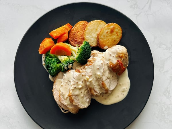 Roast chicken breast with vegetables, roast potato and mustard cream sauce