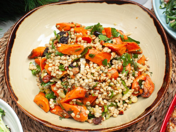 Roast Carrot, Ras el Hanout, Pearl Cous Cous, Raisin, Celery, and soft herbs