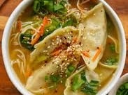 Vegetable dumplings in a spring veg and ginger soup