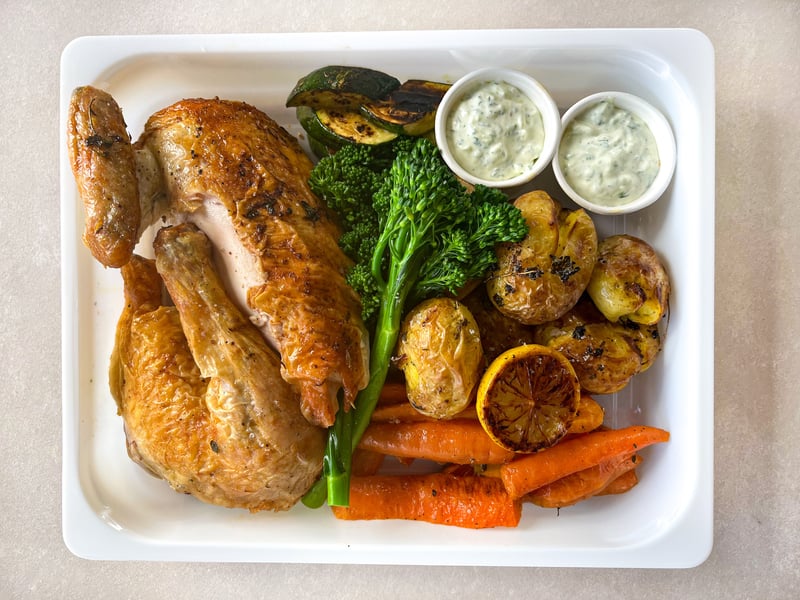 Greek chicken roast with lemon & thyme, garlic potatoes, vegetables & tzatziki